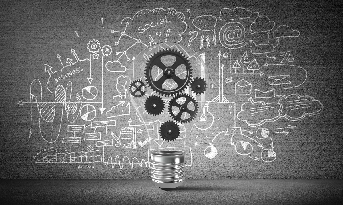 Lightbulb with multiple gears inside placed against sketched business-analytical information on grey wall. 3D rendering.